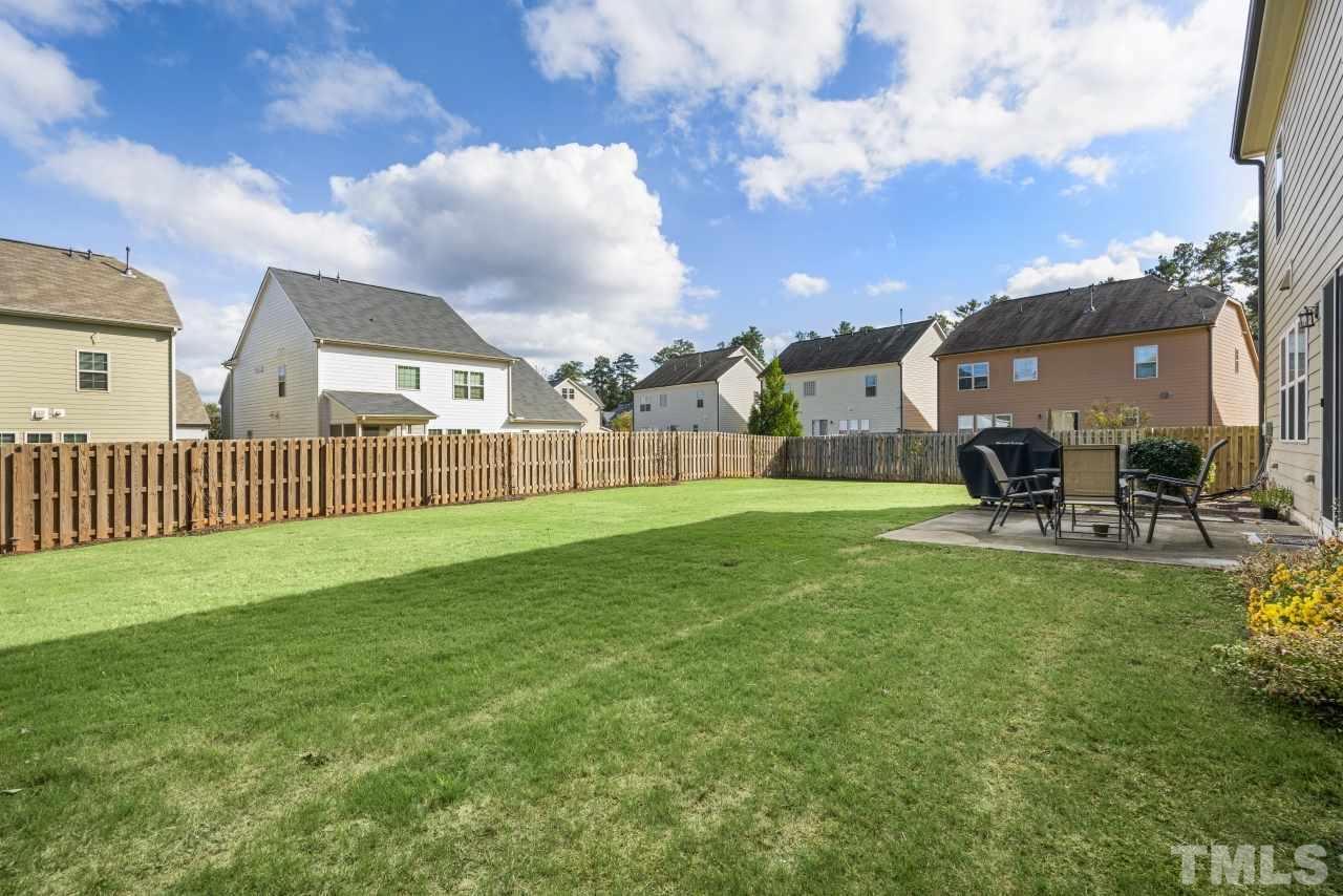2433 Pilsley Road Apex, NC 27539 - Photo 27 of 28 a view of a garden and patio