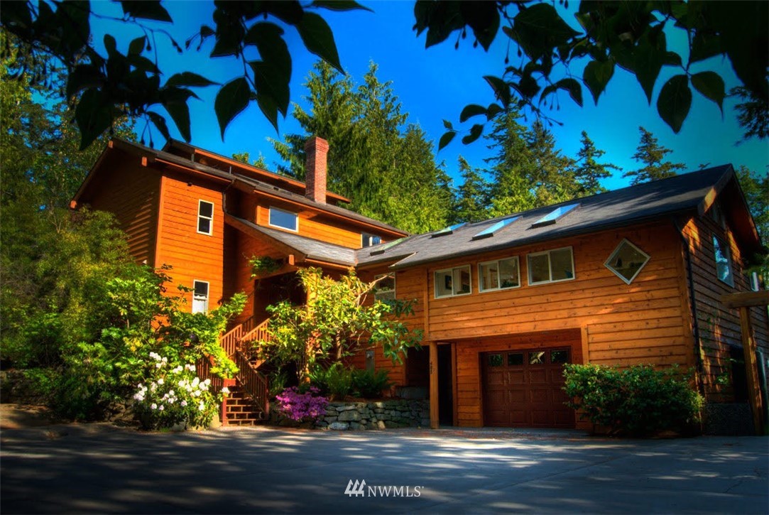 a front view of a house with a tree