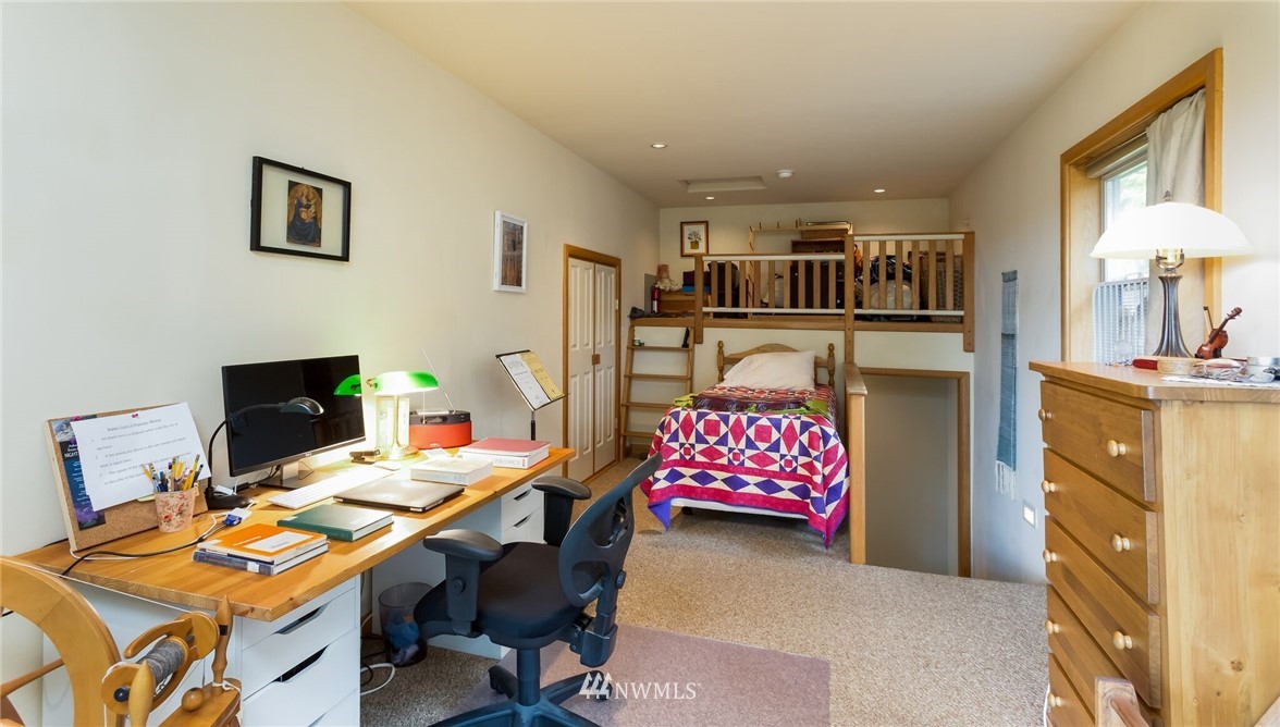 485 Whitecap Road Bellingham, WA 98229 - Photo 18 of 25 a bedroom with furniture and a chandelier