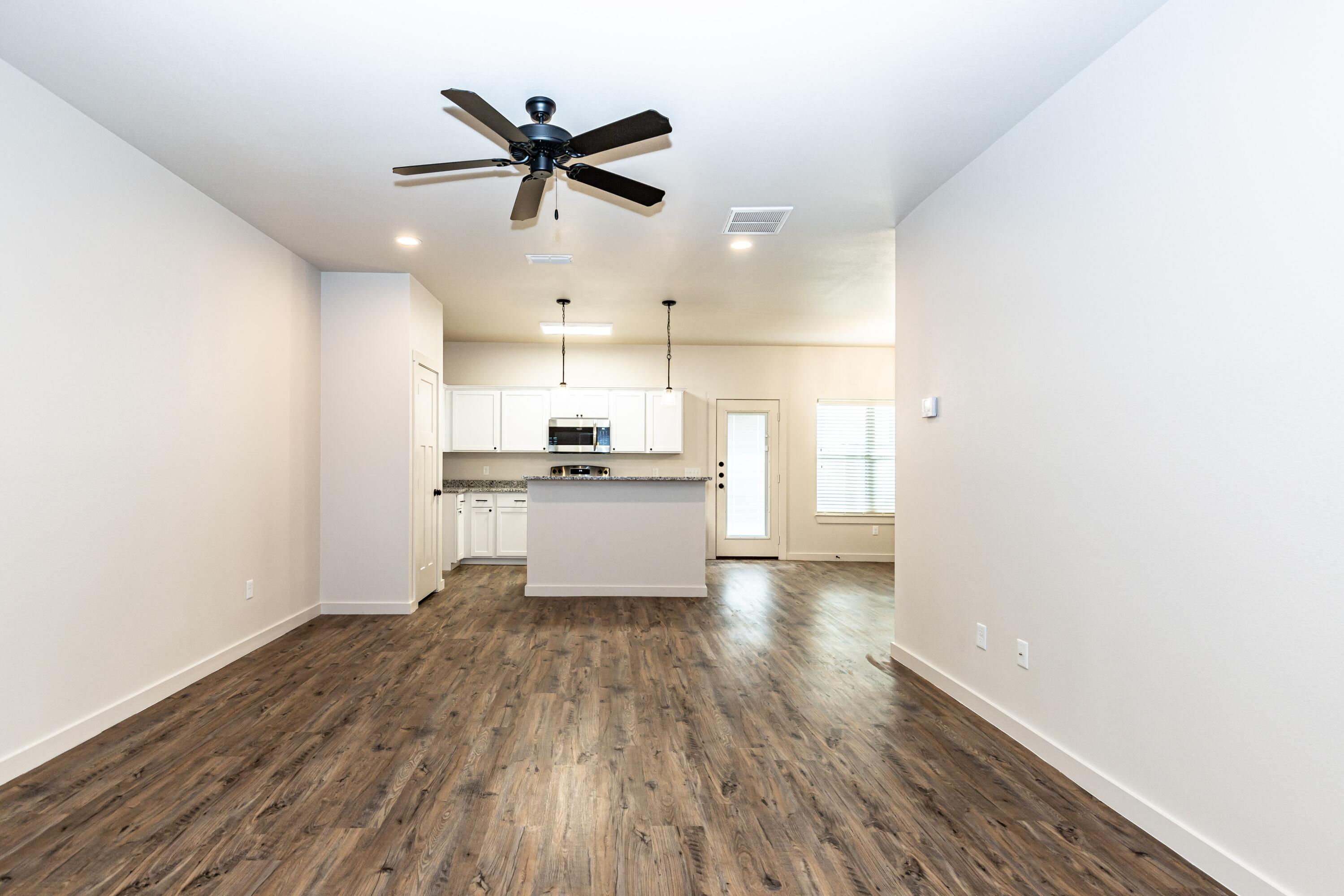 2529 138th Street Lubbock, TX 79423 - Photo 4 of 24 a view of a kitchen with a sink and wooden floor