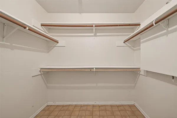 a bathroom with a granite countertop sink a mirror and shower
