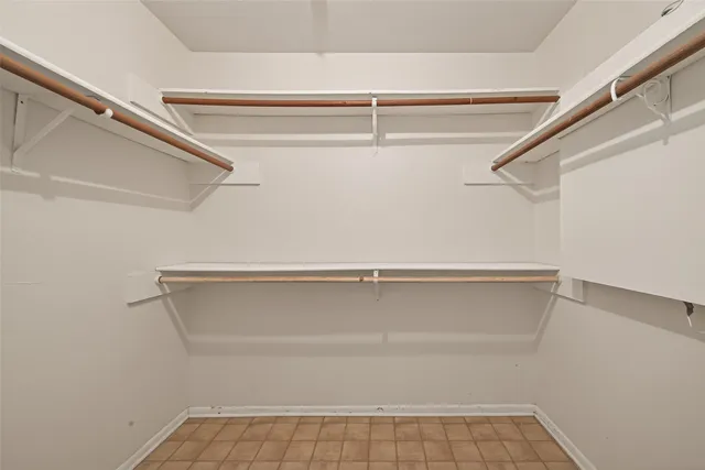 a bathroom with a granite countertop sink a mirror and shower