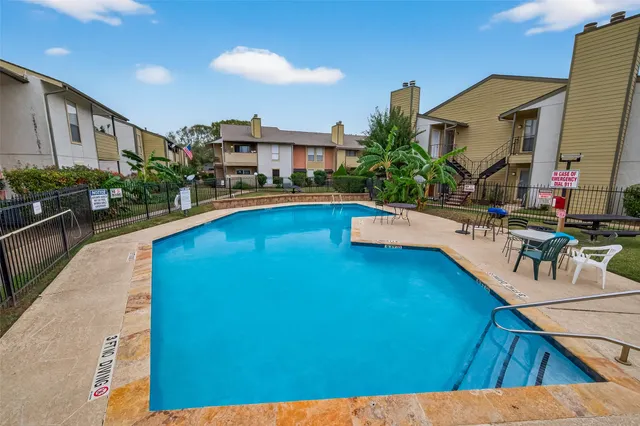 a view of a chairs and table in patio