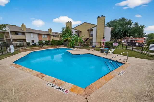 a view of swimming pool with outdoor seating