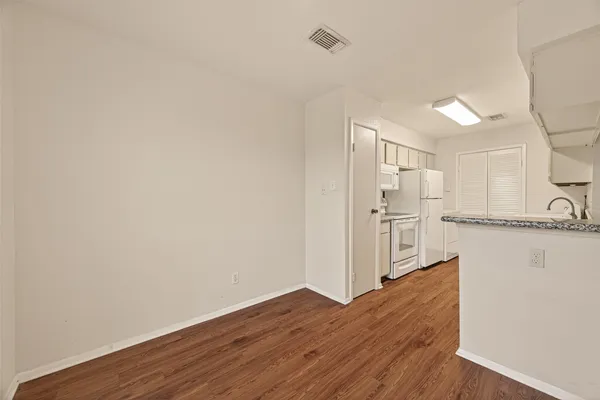 a view of a kitchen with wooden floor