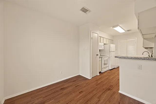 a view of a kitchen with wooden floor