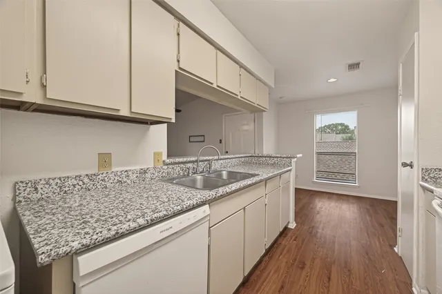 a kitchen with cabinets and appliances