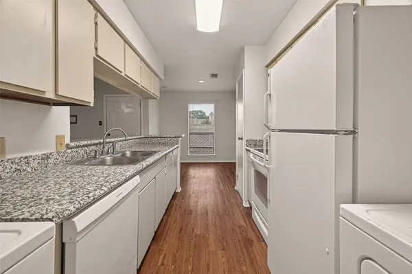 a kitchen with granite countertop a sink and cabinets