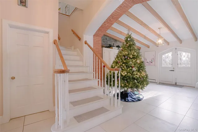 a living room with furniture large window and flat screen tv