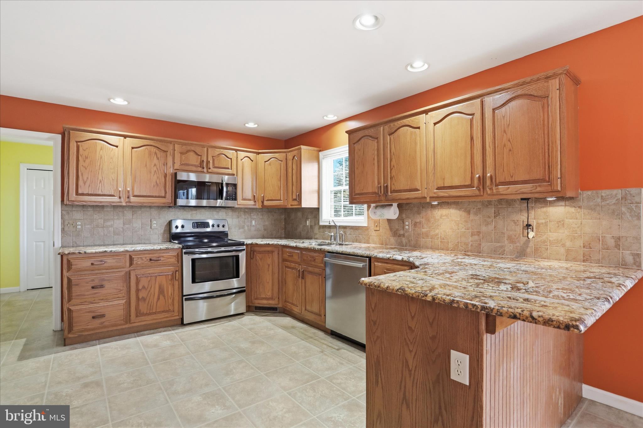 2309 Hafer Road, Unit 1 Fayetteville, PA 17222 - Photo 11 of 47 a kitchen with stainless steel appliances granite countertop a stove top oven a sink dishwasher and a refrigerator with wooden cabinets