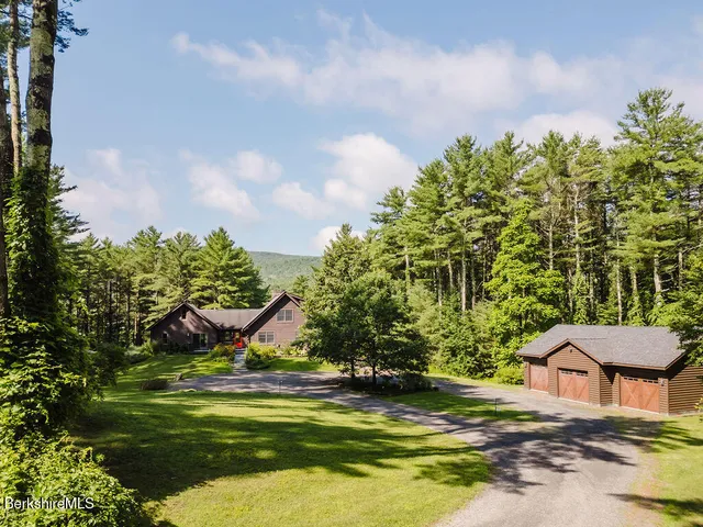 a view of house with backyard space and sitting area