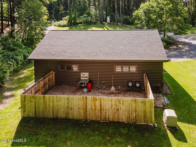 a view of staircase with lots of frames on wall and wooden floor