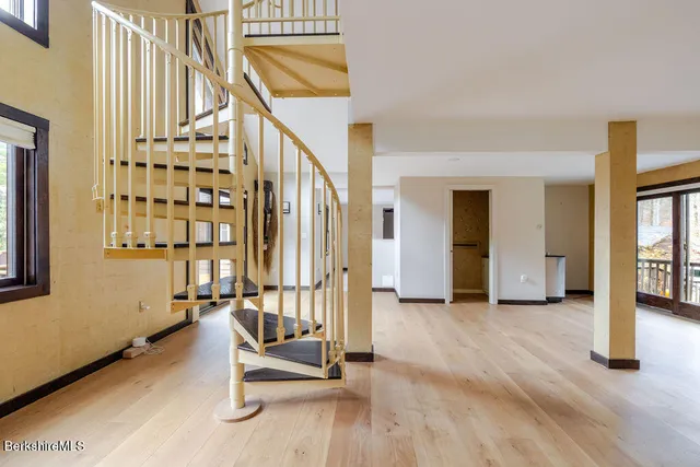 a bathroom with a granite countertop sink a mirror and a shower