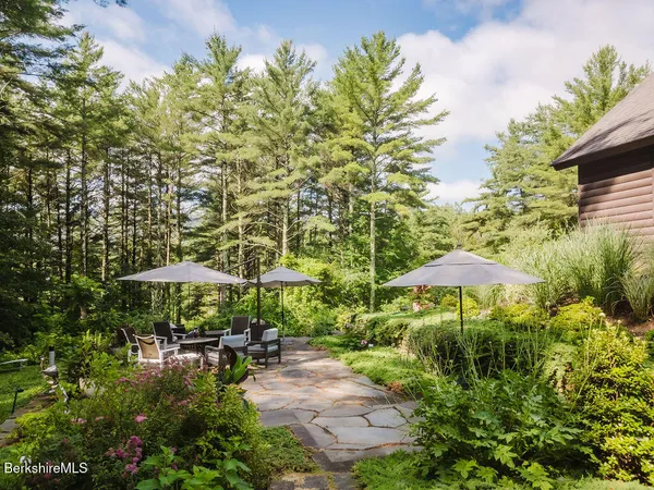 a view of house with backyard space and sitting area
