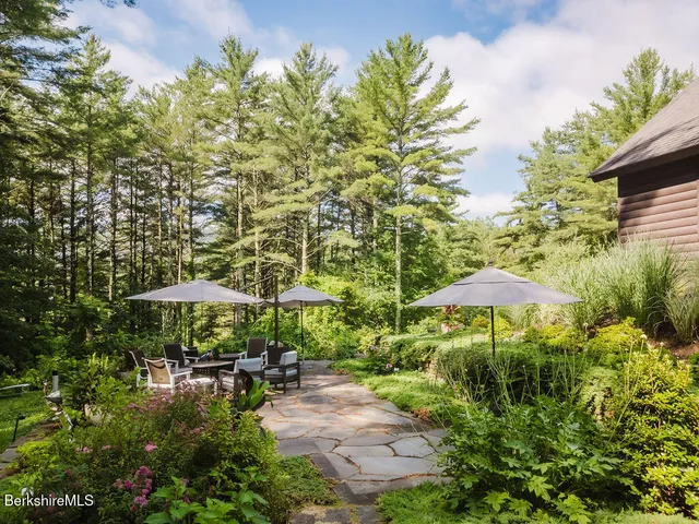 a large kitchen with stainless steel appliances granite countertop a stove a sink dishwasher and cabinets with wooden floor