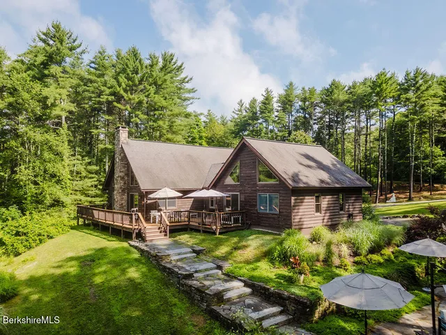 a living room with furniture fireplace and a large window
