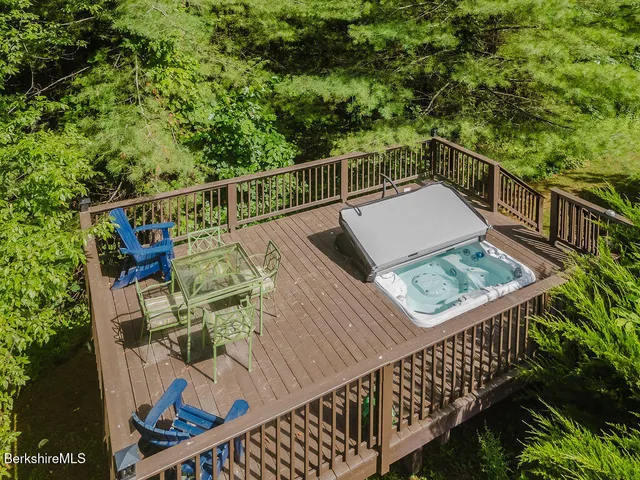 a bedroom with a bed wooden floor and window