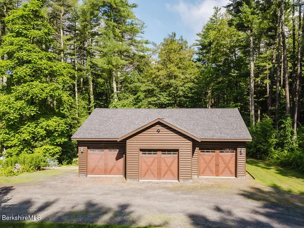 a kitchen with stainless steel appliances granite countertop a sink and wooden cabinets