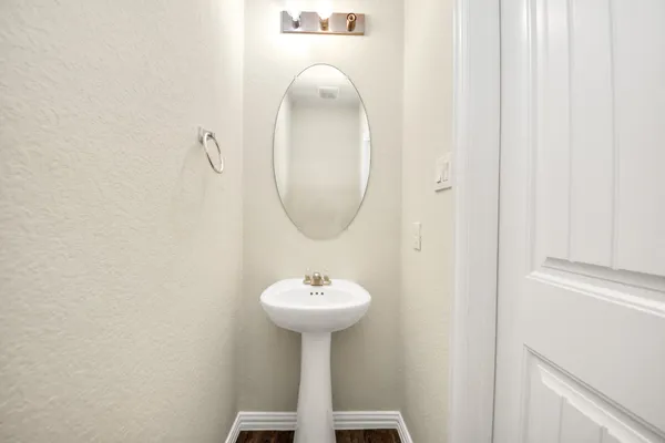an empty room with windows and a ceiling fan