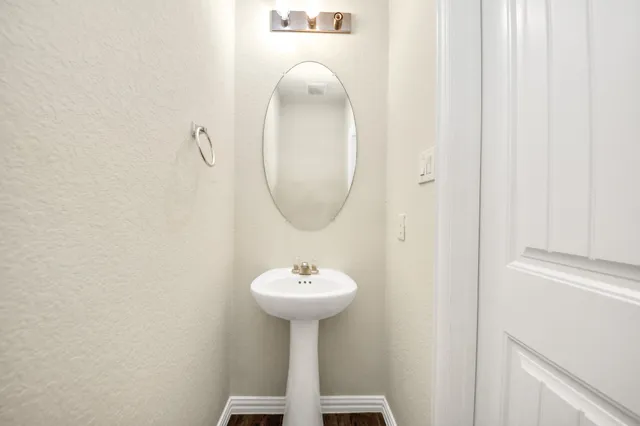 an empty room with windows and a ceiling fan