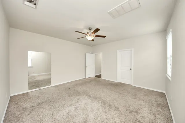 a spacious bathroom with a double vanity sink a mirror and a bathtub