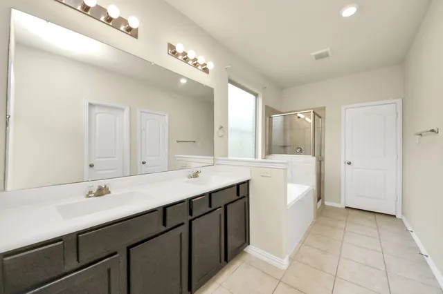 a bathroom with a double vanity sink and a mirror