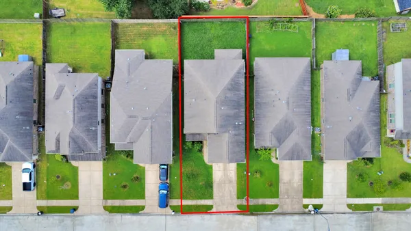 an aerial view of a house with a garden and plants