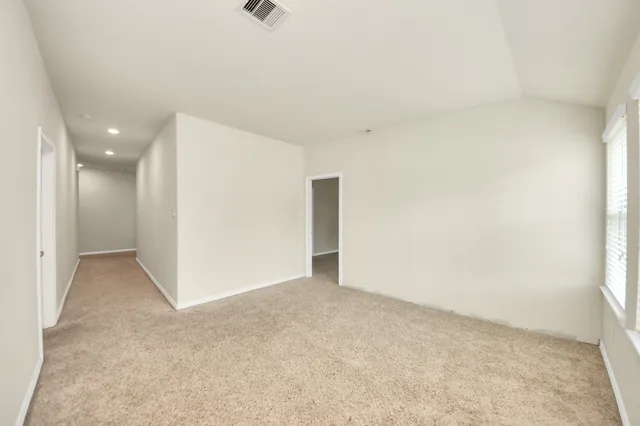 a view of an empty room with a window