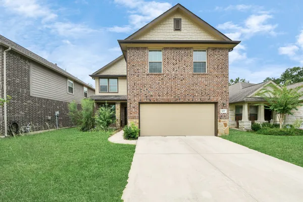 a front view of a house with garden