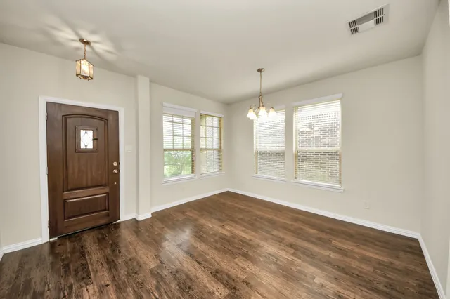a kitchen with stainless steel appliances granite countertop wooden cabinets and a stove top oven