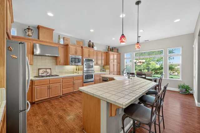 an empty room with wooden floor cabinet and flat screen tv