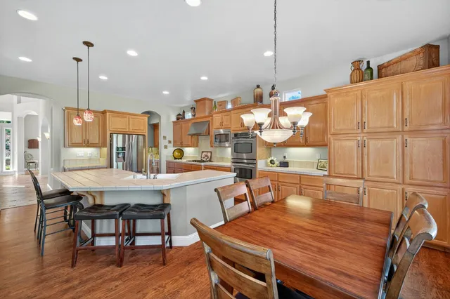 a spacious bedroom with a bed and a flat screen tv