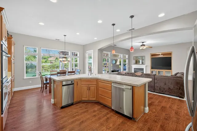 a spacious bathroom with a granite countertop tub a double vanity sink a mirror and a shower