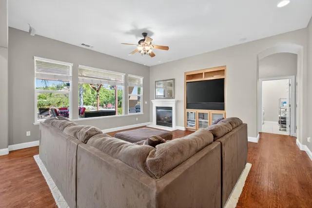 a bathroom with a granite countertop sink toilet a large mirror a shower and a bathtub