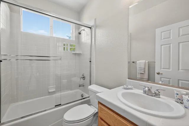 a view of a patio with table and chairs and potted plants