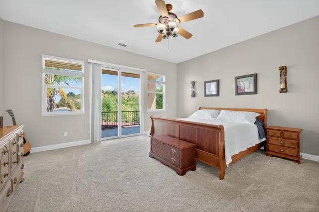 a living room with furniture a window and a clock