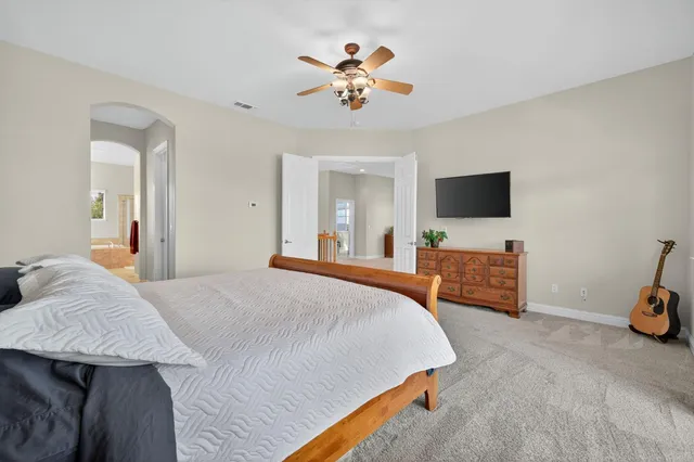 an aerial view of a house with a yard and trees