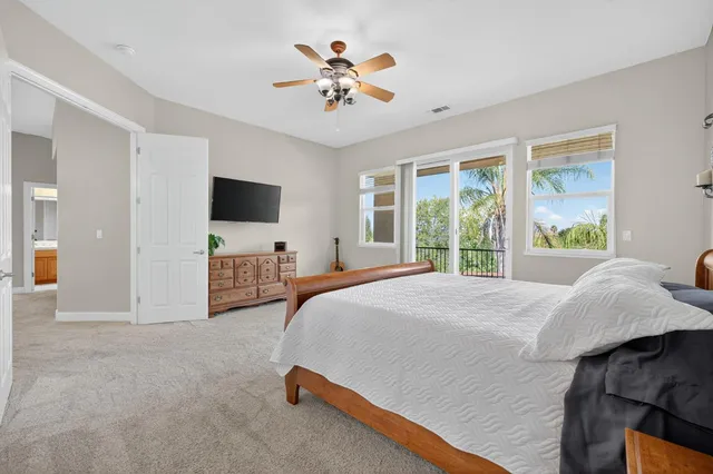 an aerial view of a house with a yard and large trees