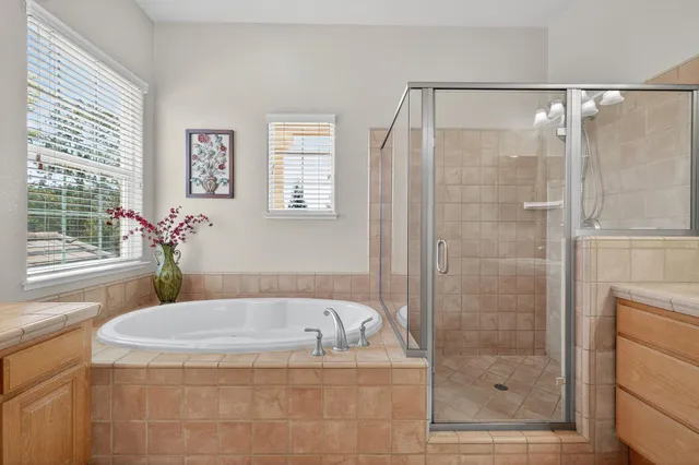 a front view of a house with a yard and fountain in middle