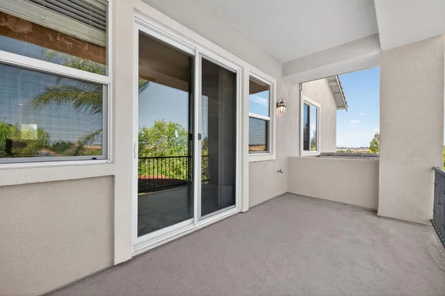 a view of a white house with a big yard and large trees