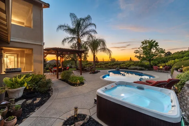 a view of a dining room with furniture a chandelier and wooden floor
