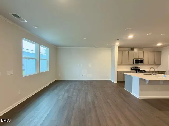 a view of kitchen with wooden floor and electronic appliances