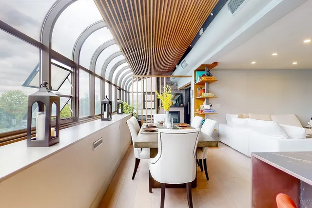 a dining room with furniture entryway and wooden floor