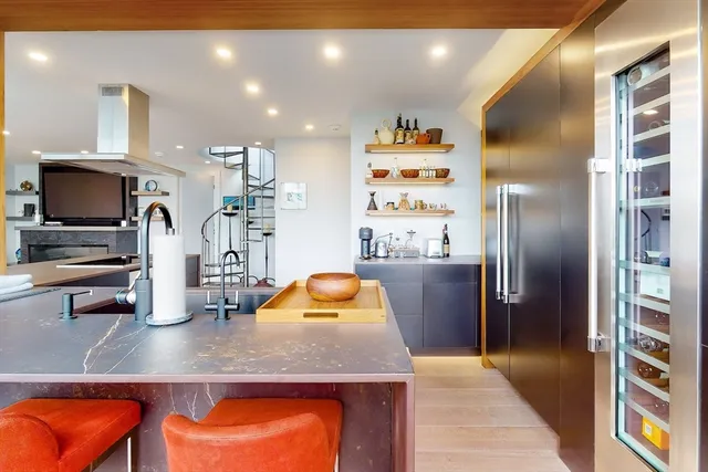 a kitchen with stainless steel appliances granite countertop a refrigerator and a sink