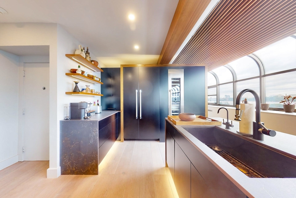 270 Beacon Street, Unit H5 Boston, MA 02116 - Photo 15 of 38 a large kitchen with stainless steel appliances granite countertop a sink and a refrigerator