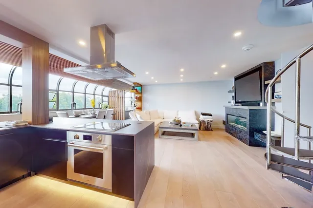 a kitchen with kitchen island a stove and a refrigerator