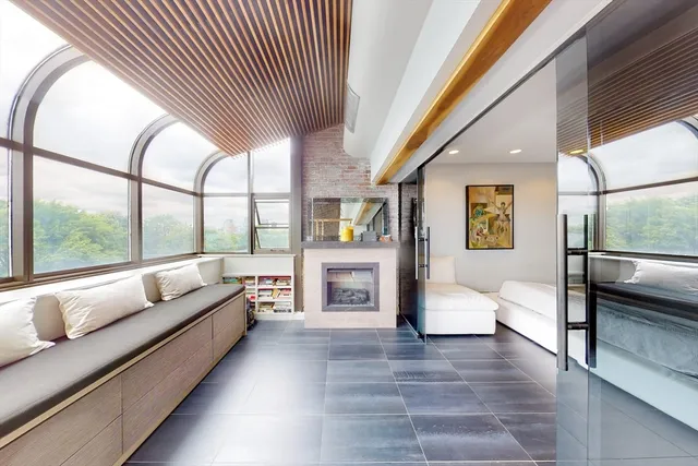 a living room with furniture and large windows