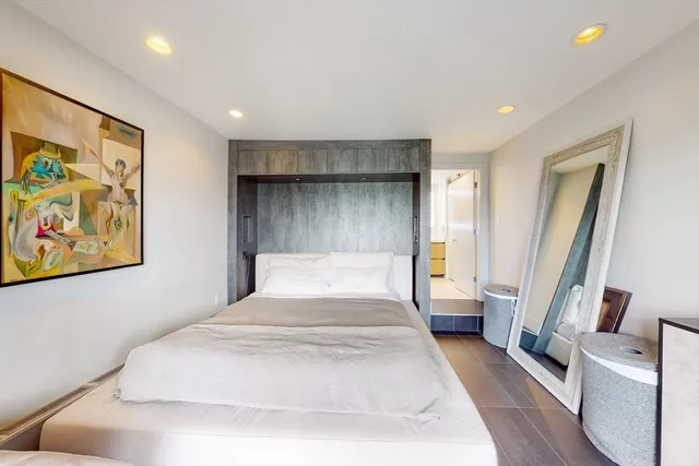 a spacious bedroom with a large bed and a couch