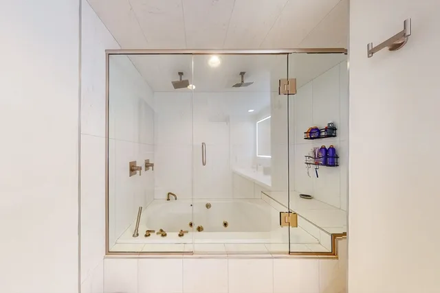 a bathroom with a bathtub and shower