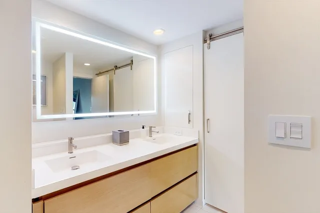 a bathroom with a double vanity sink and mirror